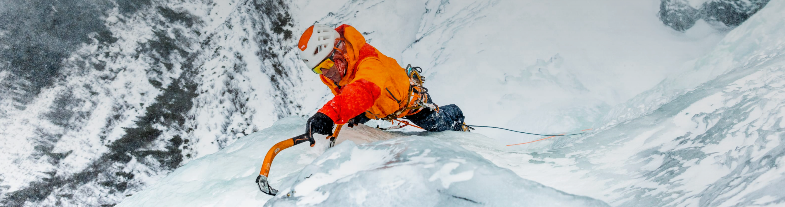 A person ice climbing in Norrona clothing and outerwear