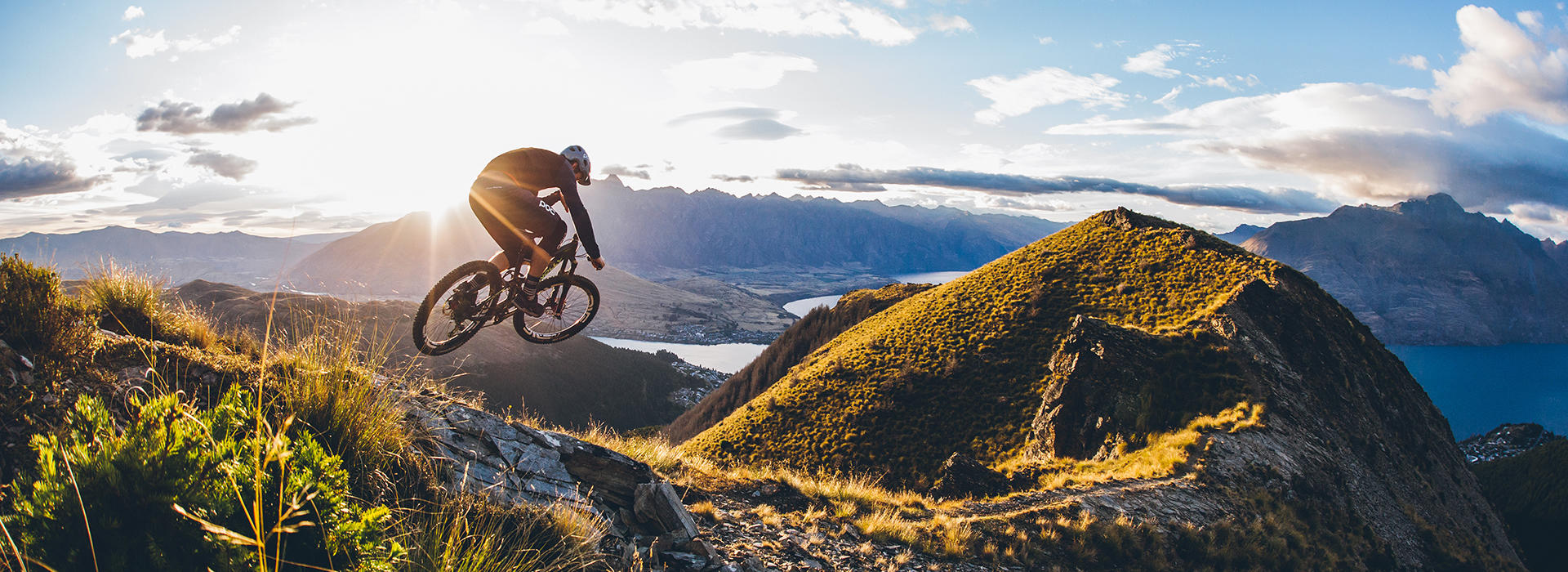 A mountain biker jumping into a sunset for outside sports